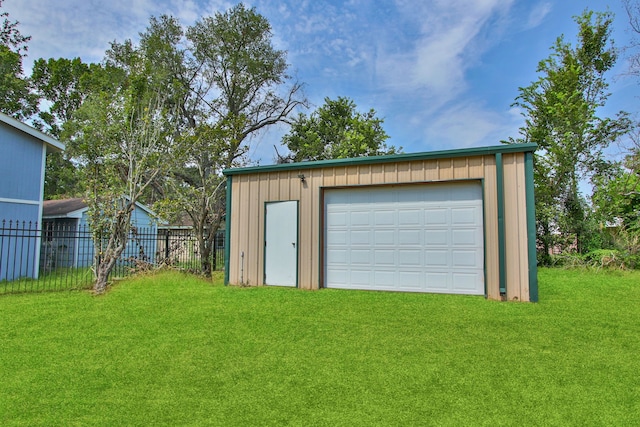 garage featuring a lawn