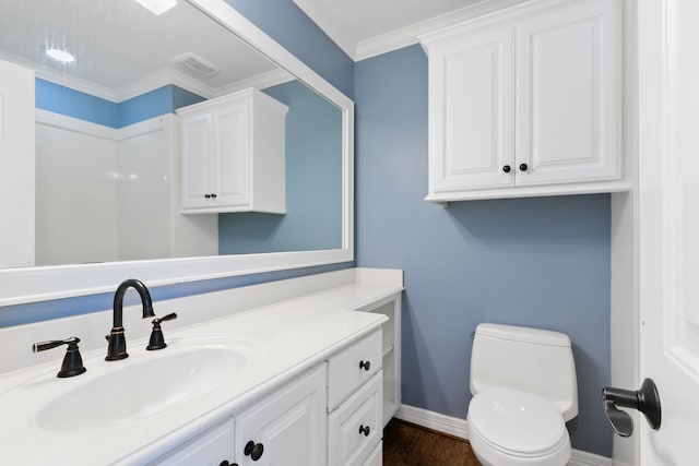 bathroom featuring vanity, toilet, hardwood / wood-style flooring, and crown molding