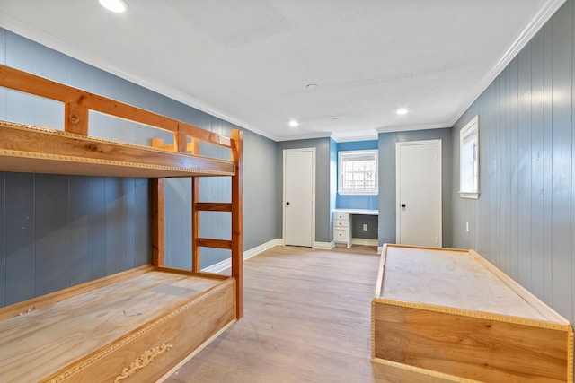 unfurnished bedroom featuring ornamental molding and light hardwood / wood-style floors