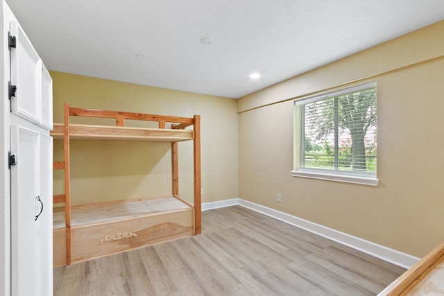 unfurnished bedroom with light wood-type flooring