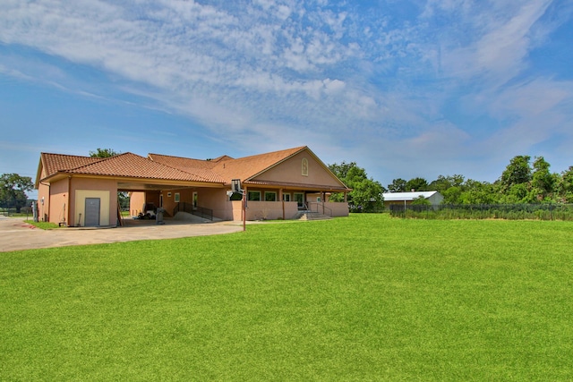 17018 Grant Rd, Cypress, TX 77429 - rear view of property featuring a tiled roof, concrete driveway, a lawn, stucco siding, and an attached carport