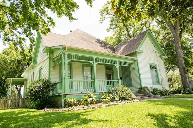 victorian home featuring a porch and a front lawn