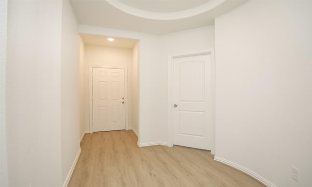 hallway with light hardwood / wood-style floors