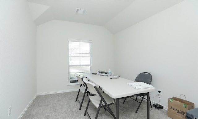 carpeted office space featuring lofted ceiling