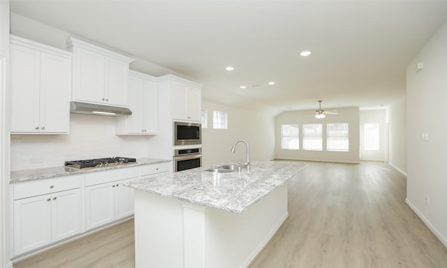 kitchen with ceiling fan, sink, a kitchen island with sink, white cabinets, and appliances with stainless steel finishes