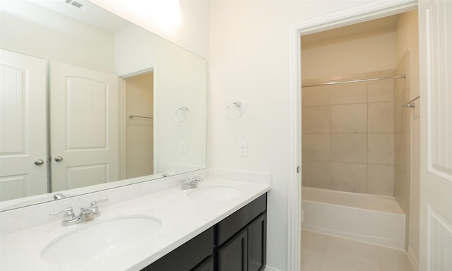 full bathroom with tile patterned flooring, vanity, toilet, and tiled shower / bath