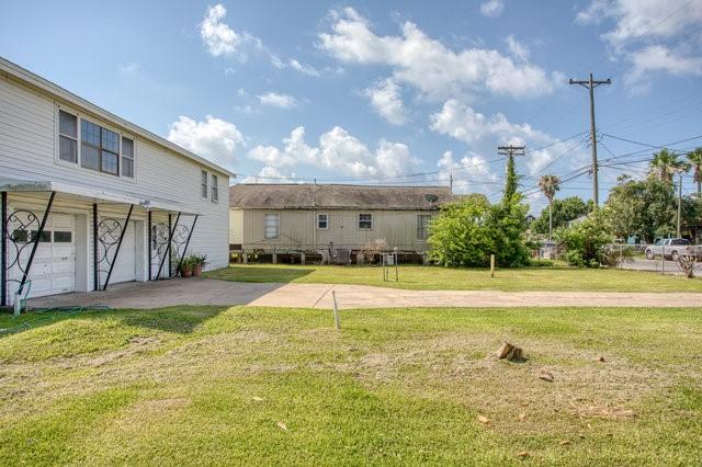 view of yard featuring driveway and an attached garage