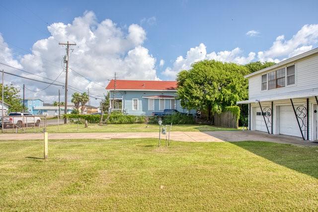 view of yard with concrete driveway and an attached garage