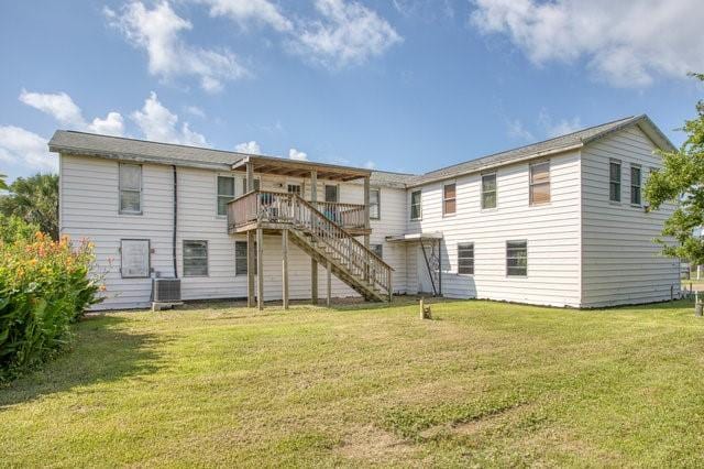 rear view of property with stairs, a yard, a wooden deck, and central air condition unit