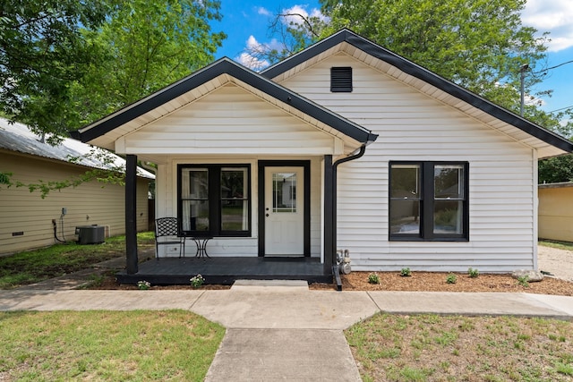 bungalow-style home with central AC unit and a porch