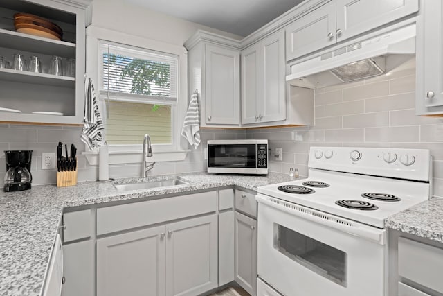 kitchen featuring light stone countertops, tasteful backsplash, white electric range oven, sink, and white cabinetry