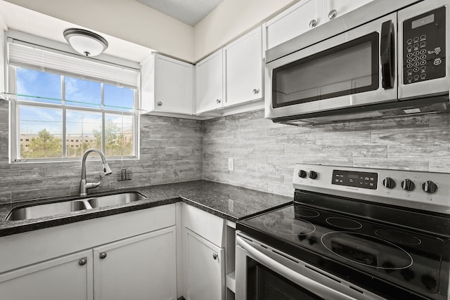 kitchen featuring appliances with stainless steel finishes, sink, tasteful backsplash, and white cabinets