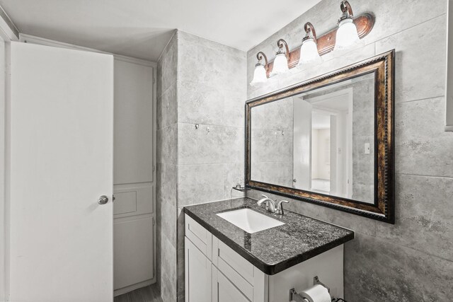 bathroom featuring tile walls and vanity