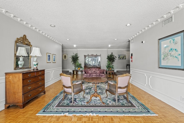 dining space with a textured ceiling and light parquet floors