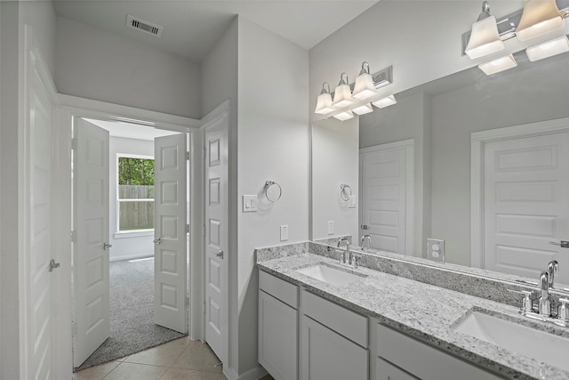 bathroom featuring tile patterned flooring and dual bowl vanity