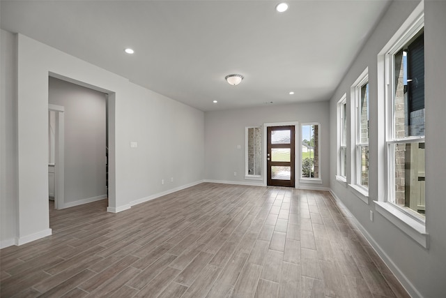 empty room with hardwood / wood-style floors