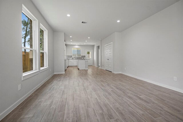 unfurnished living room featuring light hardwood / wood-style flooring