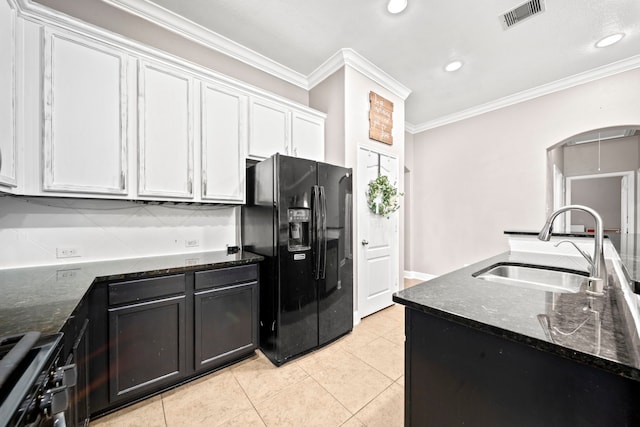 kitchen featuring gas range, black refrigerator with ice dispenser, white cabinets, ornamental molding, and sink