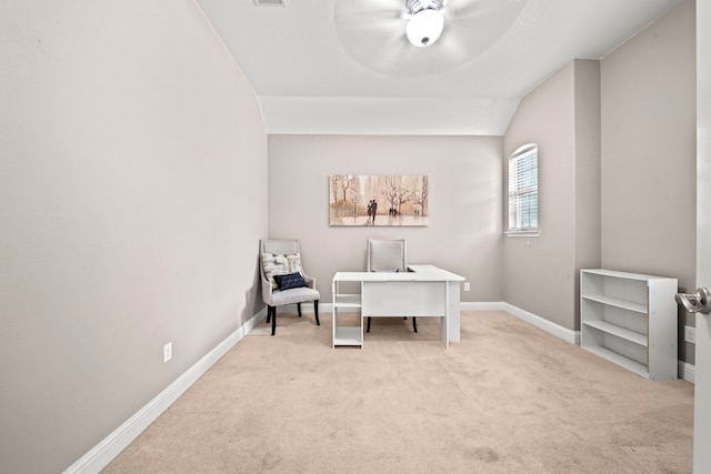 carpeted home office with lofted ceiling and ceiling fan