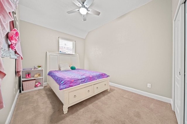 carpeted bedroom featuring ceiling fan, a closet, and vaulted ceiling