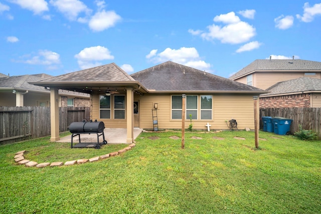 back of house featuring a patio area, ceiling fan, and a lawn