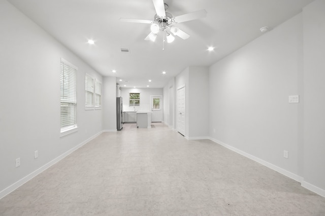 unfurnished living room with ceiling fan