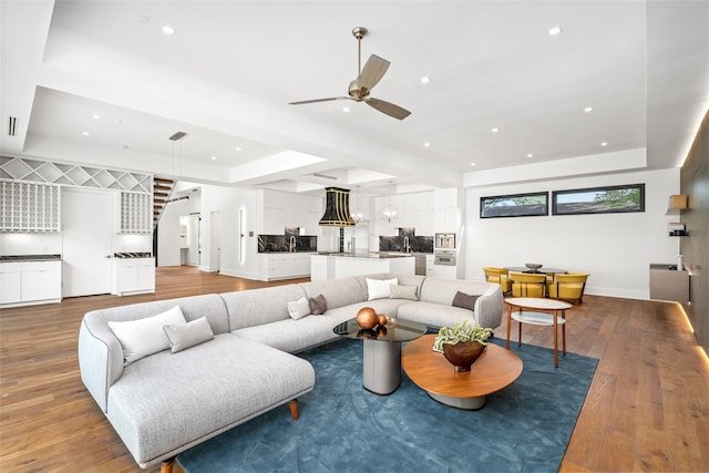 living room with light wood-type flooring and ceiling fan