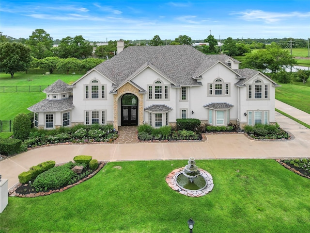 view of front of house featuring a front yard and french doors