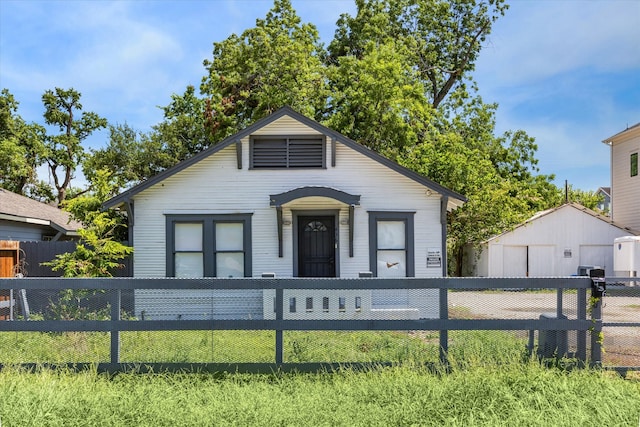 bungalow-style home with a front yard