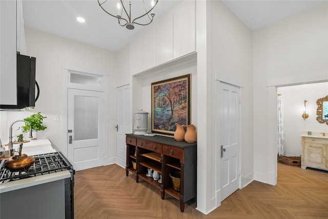 hallway with a chandelier, light parquet flooring, and sink