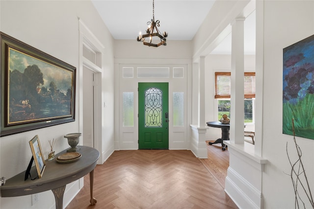 entrance foyer featuring parquet flooring and an inviting chandelier