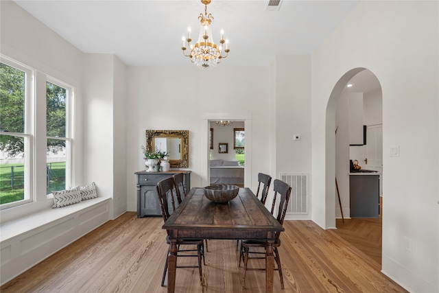 dining room featuring light hardwood / wood-style flooring and a notable chandelier