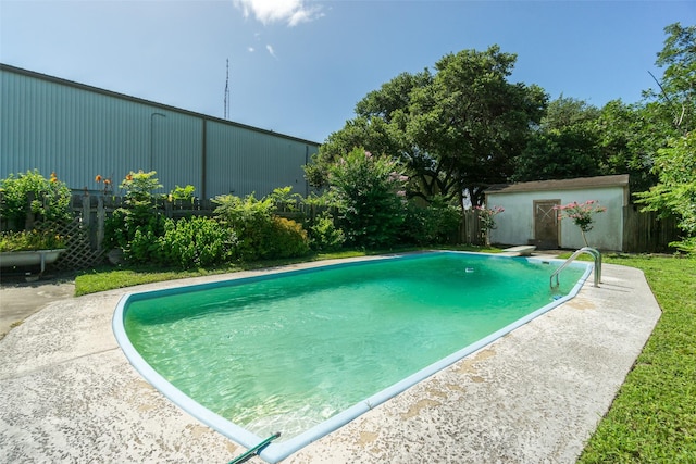 outdoor pool featuring a diving board and an outdoor structure