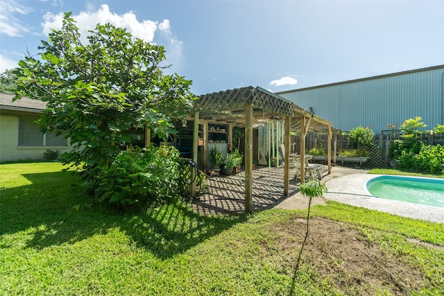 rear view of house featuring a patio area, a pergola, and a lawn