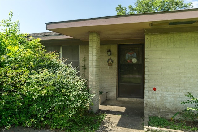 property entrance with brick siding