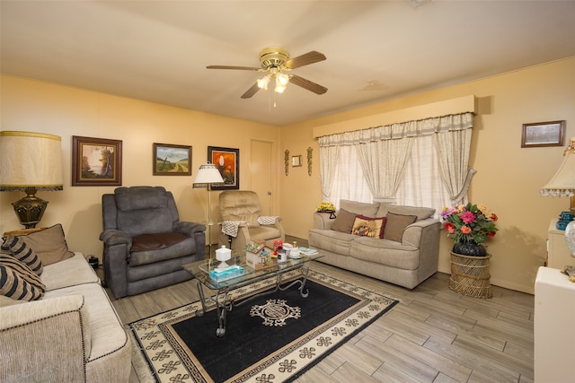 living room featuring ceiling fan and light wood-type flooring