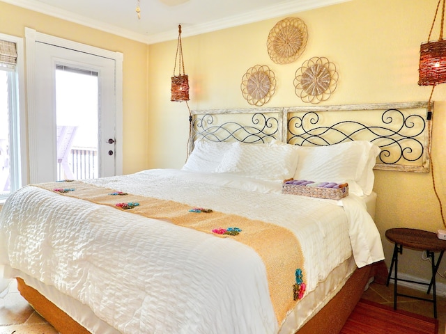 bedroom with access to outside and crown molding