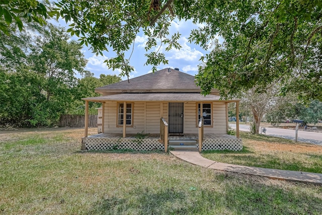 bungalow-style home with a front lawn and a porch