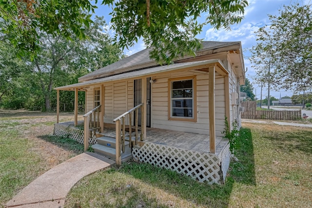 bungalow-style home with a front lawn