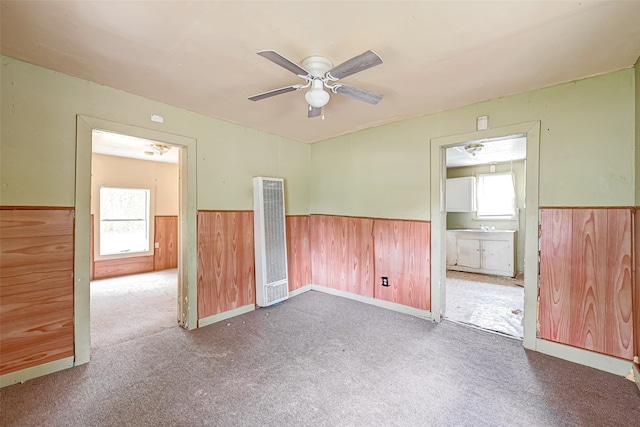 unfurnished room with carpet flooring, plenty of natural light, and ceiling fan