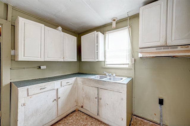 kitchen with sink, white cabinets, and light tile floors