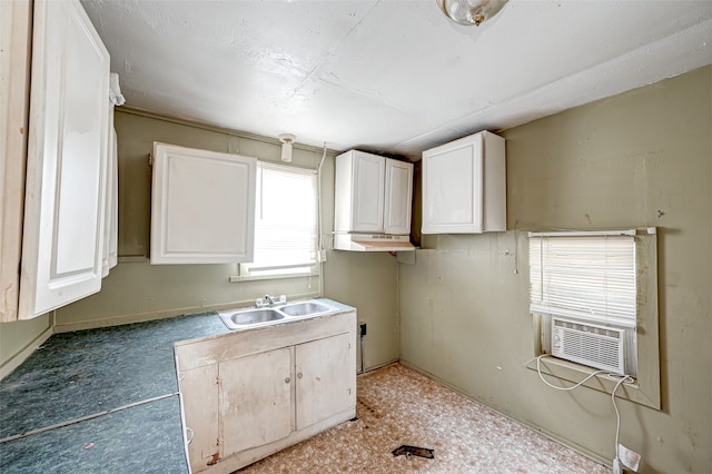 kitchen featuring sink and white cabinetry