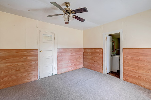 unfurnished bedroom featuring ceiling fan and dark colored carpet