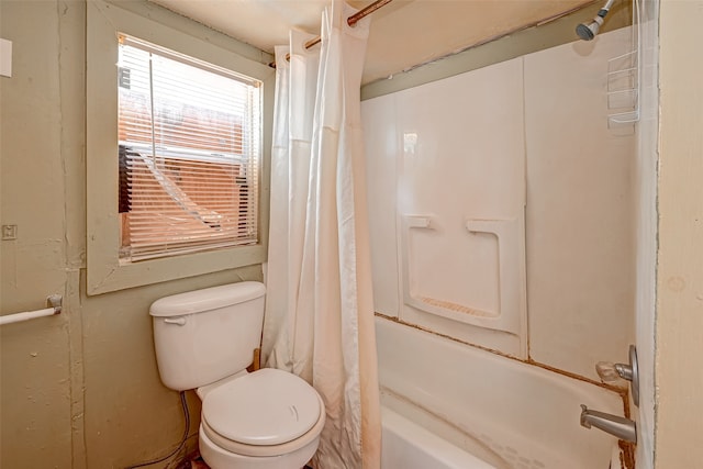 bathroom featuring toilet and shower / bath combo