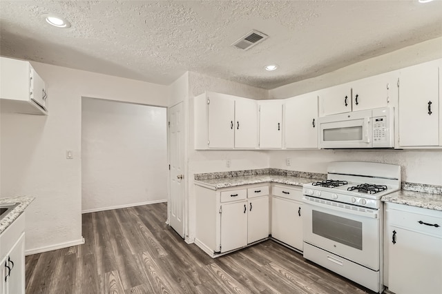 kitchen featuring a textured ceiling, white cabinetry, dark hardwood / wood-style flooring, and white appliances