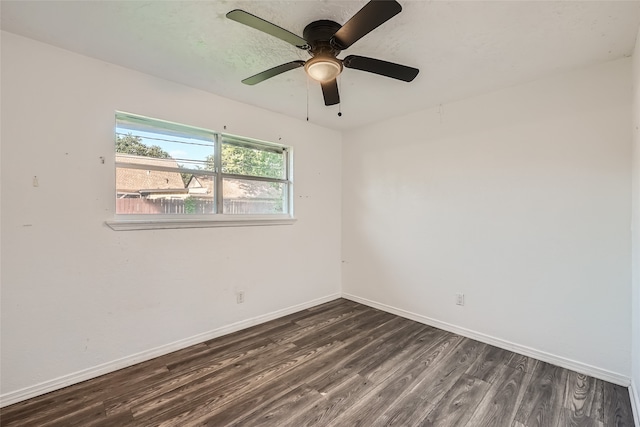 empty room with dark hardwood / wood-style flooring and ceiling fan