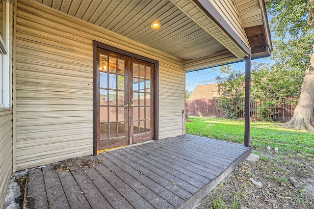 deck with a yard and french doors