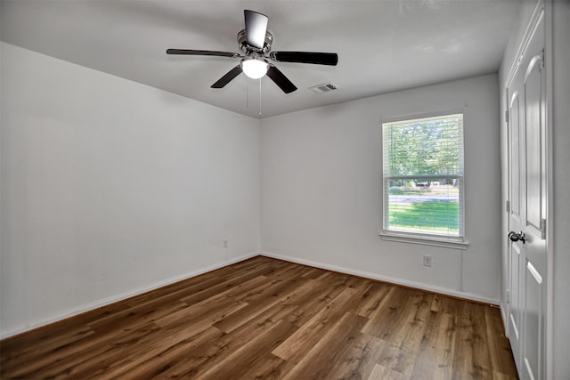 spare room with hardwood / wood-style floors and ceiling fan