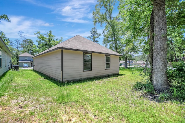 view of side of property featuring a yard