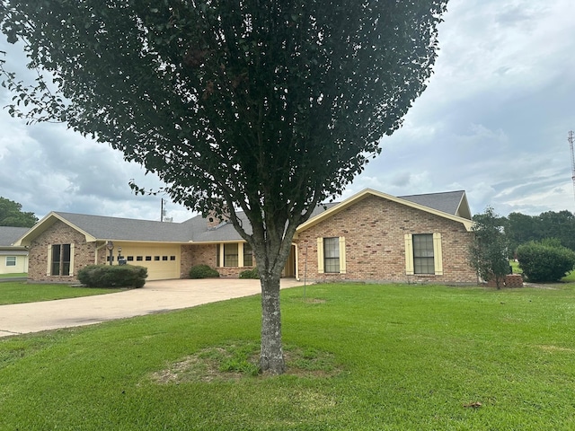 single story home featuring a garage and a front lawn